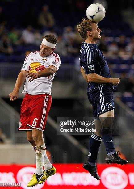 Teemu Tainio of the New York Red Bulls and Seth Sinovic of the Sporting KC vie for the ball at Red Bull Arena on September 19, 2012 in Harrison, New...