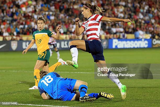 Goalkeeper Brianna Davey of Australia collects the ball as Alex Morgan of the USA leaps over her at Dick's Sporting Goods Park on September 19, 2012...