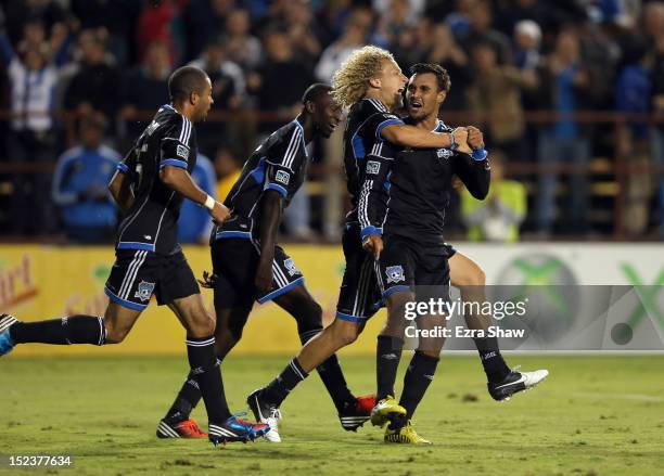 Chris Wondolowski of the San Jose Earthquakes celebrates with Steven Lenhart after he scored his second goal of their game against the Portland...