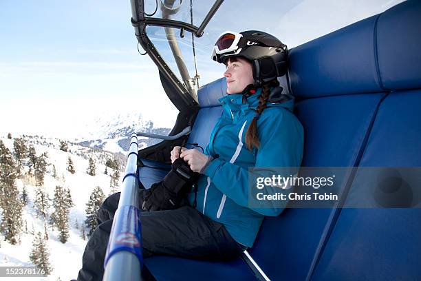 young woman on ski lift - sessellift stock-fotos und bilder