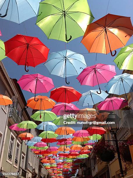 colored umbrellas - multi coloured umbrella stock pictures, royalty-free photos & images