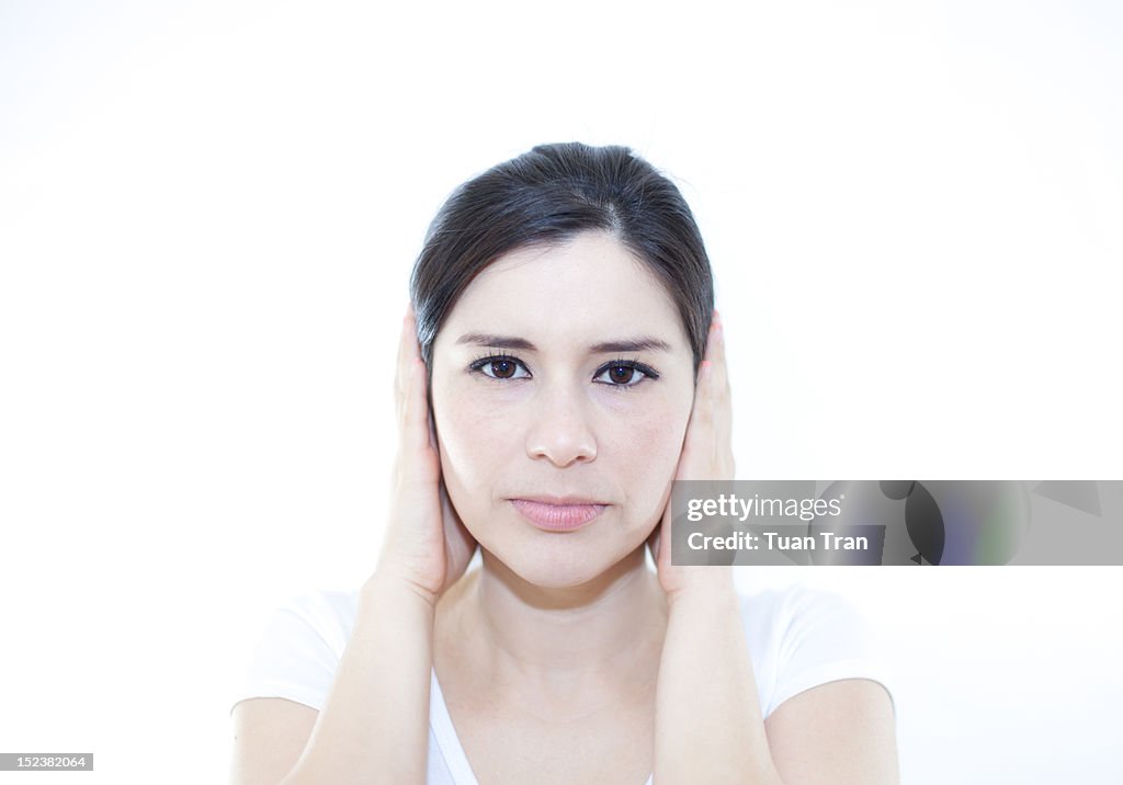 Woman covering her ears