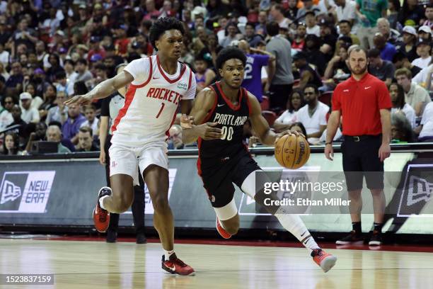 Scoot Henderson of the Portland Trail Blazers dribbles the ball against Amen Thompson of the Houston Rockets during the third quarter at the Thomas &...