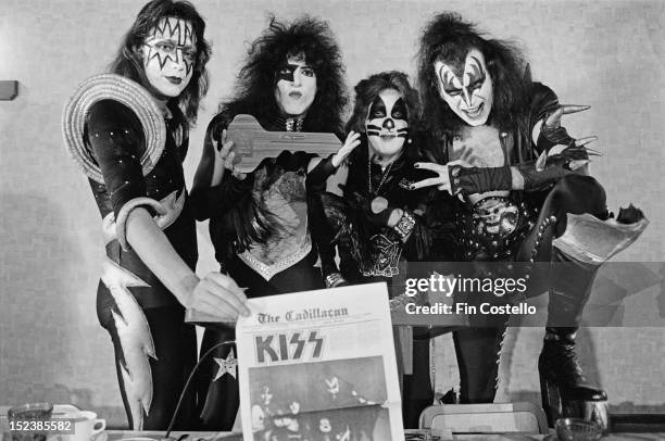 9th OCTOBER: Amercan rock band Kiss pose in City Hall with the Cadillacian newspaper during the 'Day in the Life of a Town' in Cadillac, Michigan on...