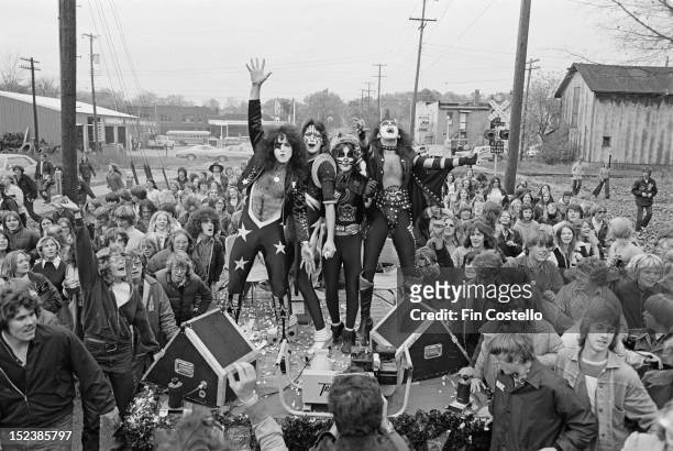9th OCTOBER: Amercan rock band Kiss pose on the back of a truck surrounded by fans during the 'Day in the Life of a Town' in Cadillac, Michigan on...