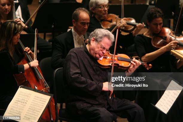 The violinist Itzhak Perlman performing with the New York Philharmonic, conducted by Daniel Boico, in "A Concert to End Polio" at Avery Fisher Hall...