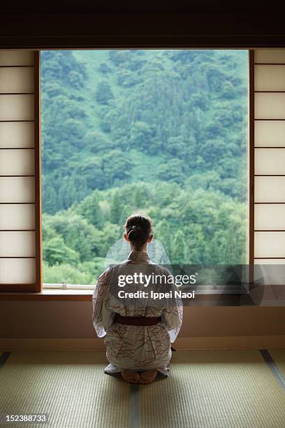 woman meditating in japanese room - tatami mat stock pictures, royalty-free photos & images