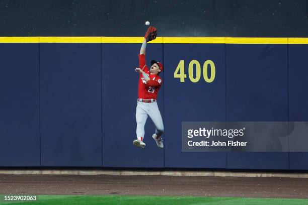 Friedl of the Cincinnati Reds makes a leaping catch at the wall in the third inning against the Milwaukee Brewers at American Family Field on July...