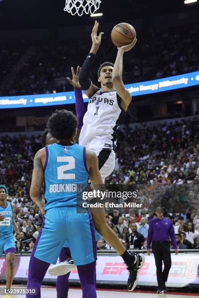 Victor Wembanyama of the San Antonio Spurs shoots the ball against James Bouknight of the Charlotte Hornets during the first quarter at the Thomas &...