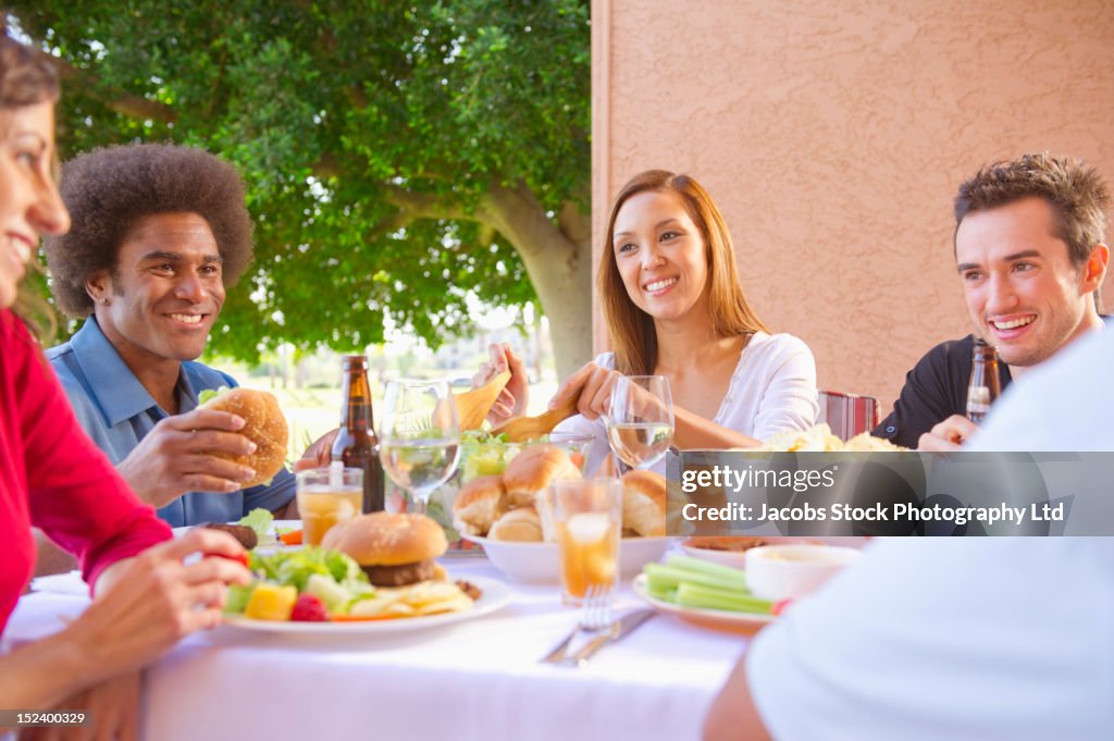 Friends eating together outdoors