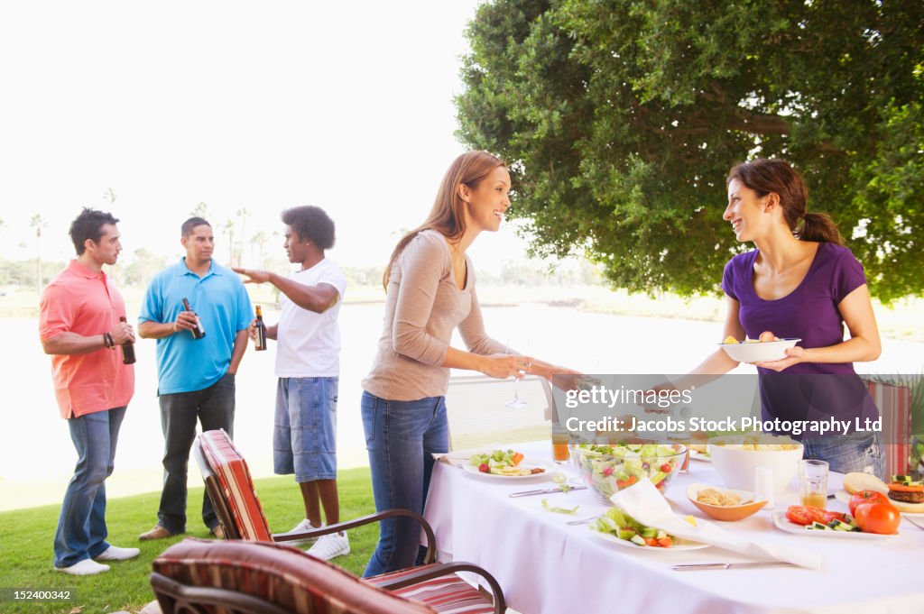 Friends eating together outdoors