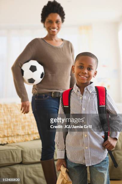 black mother and son getting ready for the day - soccer mom stock pictures, royalty-free photos & images