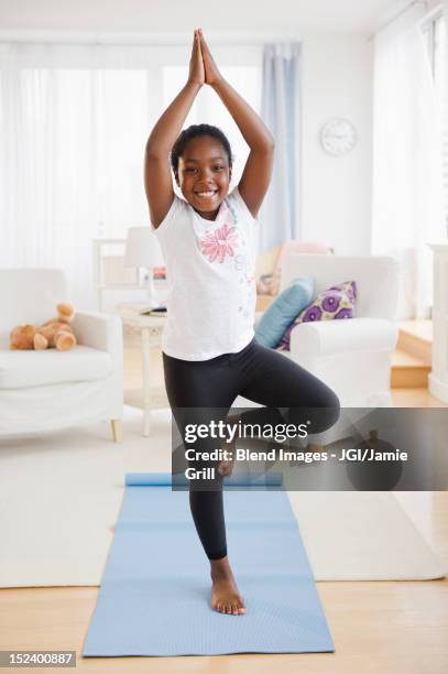 black girl practicing yoga - standing on one leg fotografías e imágenes de stock