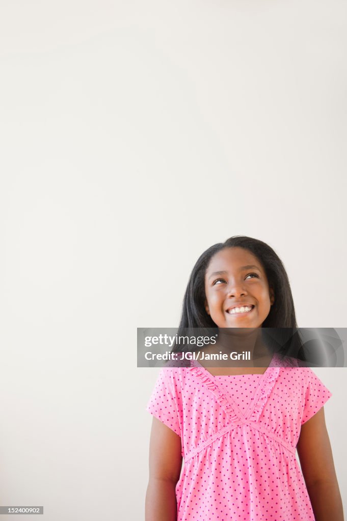 Smiling Black girl looking up