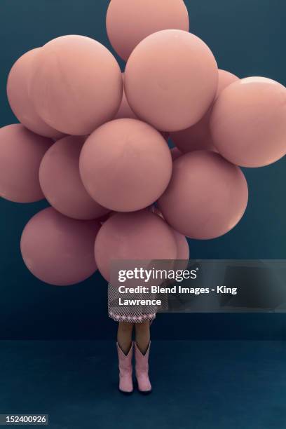 caucasian girl holding large balloons - child balloon studio photos et images de collection