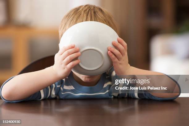 caucasian boy eating from bowl - bowl of cereal ストックフォトと画像