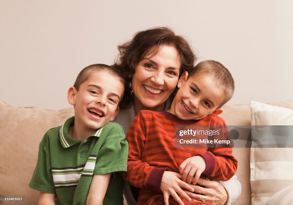 Caucasian grandmother sitting with grandsons