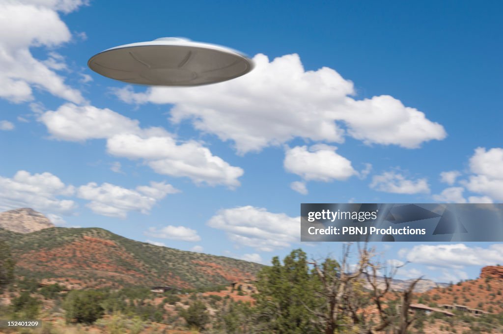 UFO flying over desert