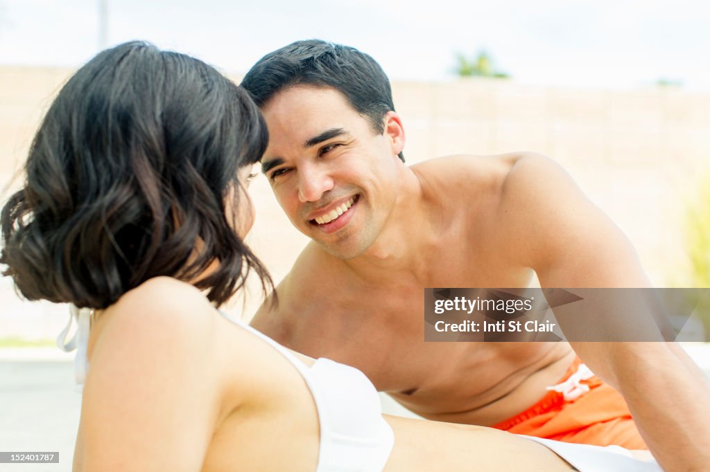 Couple in bathing suits flirting