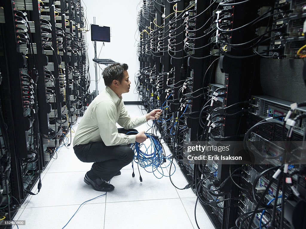 Asian businessman working in server room