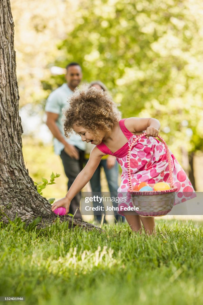 Mixed race girl on Easter egg hunt