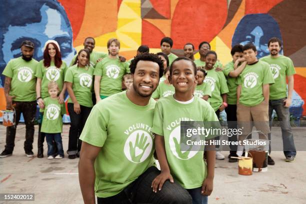 volunteers standing together - center street elementary stock pictures, royalty-free photos & images