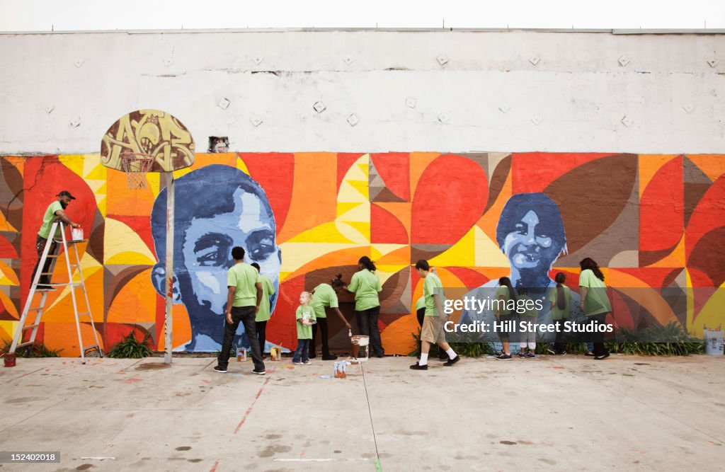 Volunteers painting wall together