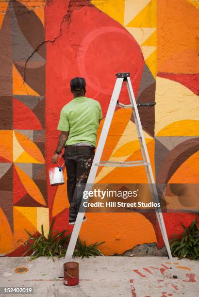 black man painting wall - artsy stock pictures, royalty-free photos & images