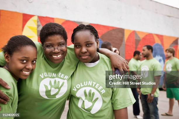 smiling volunteers hugging - sisters of charity stock-fotos und bilder