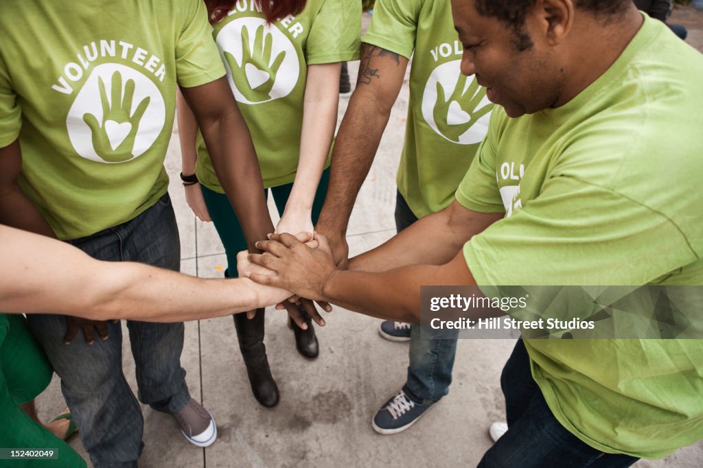 Volunteers holding hands in circle