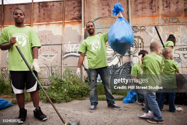 volunteers picking up litter - cleaning graffiti stock pictures, royalty-free photos & images