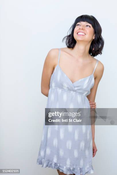 smiling mixed race woman - cut out dress foto e immagini stock