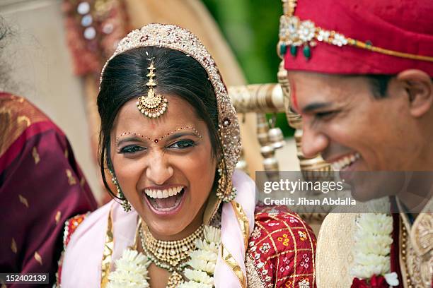 indian bride and groom in traditional clothing - wedding couple laughing photos et images de collection