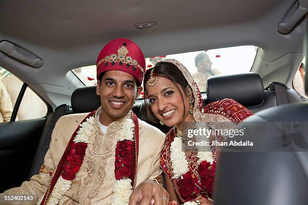 indian bride and groom in traditional clothing in car - indian royalty stock pictures, royalty-free photos & images