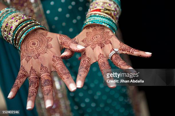 close up of henna on indian woman's hands - henna hands stock-fotos und bilder