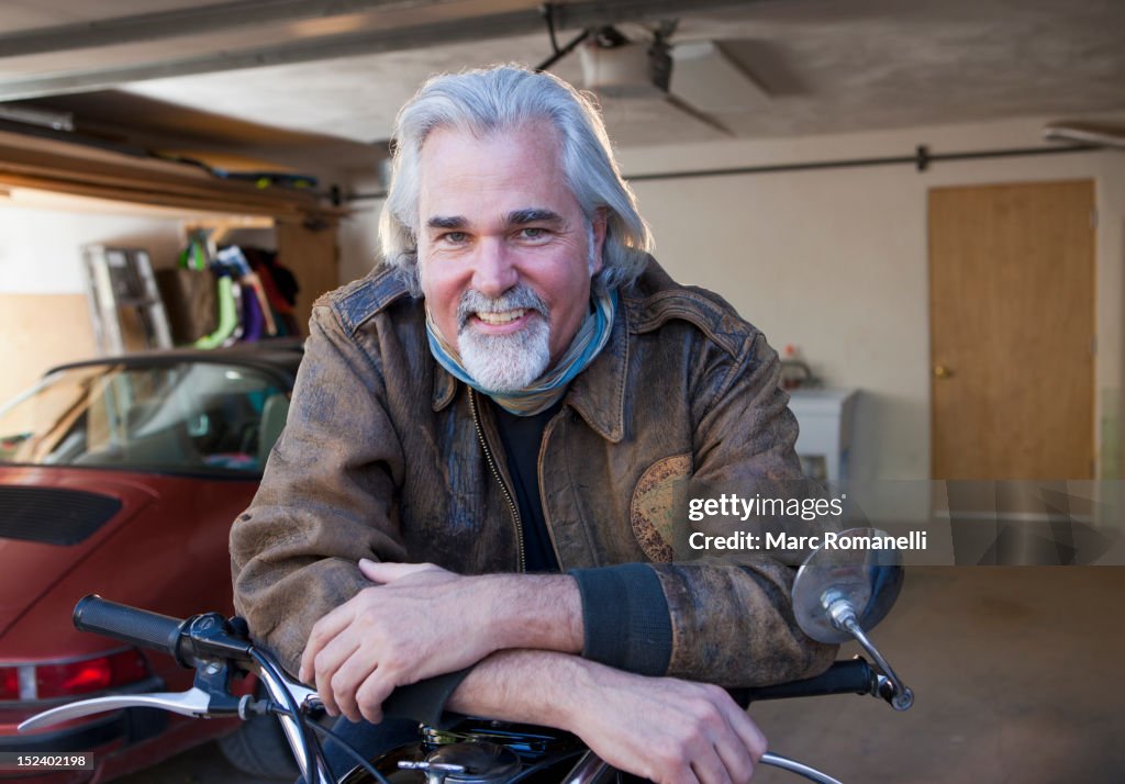 Caucasian man in garage with motorcycle
