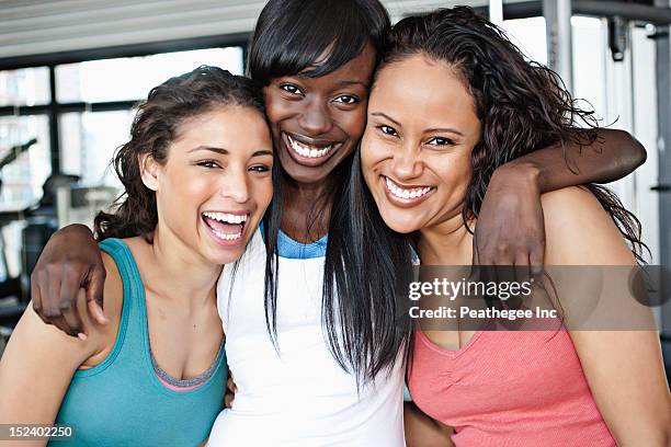 smiling women hugging in health club - health club 個照片及圖片檔