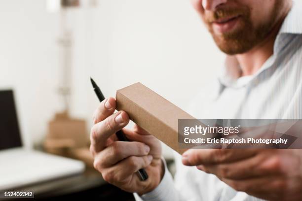 caucasian businessman looking at prototype - pen mockup stock-fotos und bilder