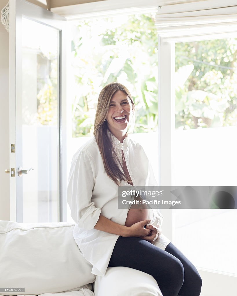 Smiling pregnant Hispanic woman
