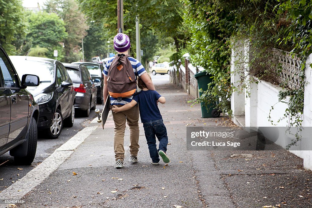Brothers walking down the road arm in arm