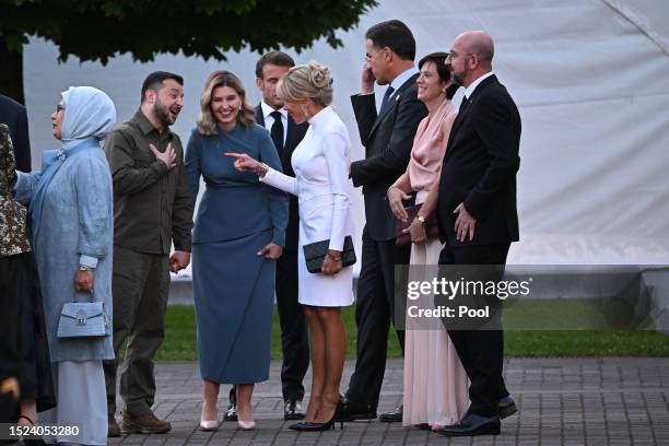 Ukrainian President Volodymyr Zelensky and his wife Olena Zelenska talk with French President Emmanuel Macron and his wife Brigitte Macron upon...