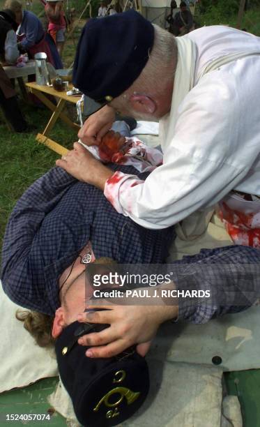 Civil War Surgeon Art Bennett of Chantilly, Va, conducts battlefield surgery on an injured soldier during the First Manassas Civil War Reenactment 04...
