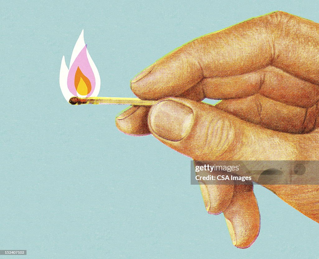 Hand Holding Lit Match