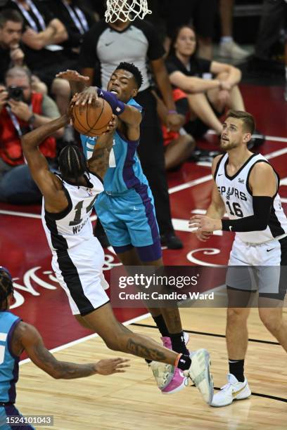 Brandon Miller of the Charlotte Hornets blocks the shot attempt of Blake Wesley of the San Antonio Spurs during the third quarter at the Thomas &...