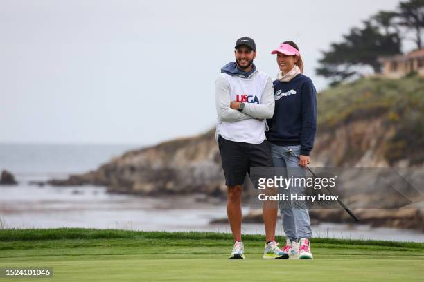 Michelle Wie West of the United States stands with her caddie and husband Jonnie West after making her putt for par on the 18th green during the...