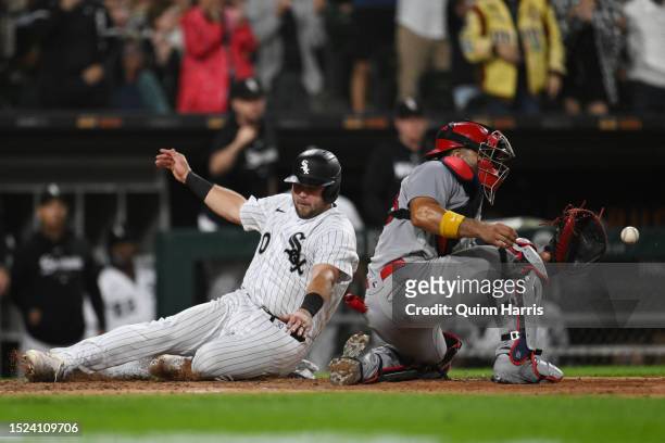 Jake Burger of the Chicago White Sox beats the throw at home to score in the sixth inning against Ivan Herrera of the St. Louis Cardinals at...
