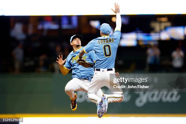 Willy Adames and Brice Turang of the Milwaukee Brewers celebrate a win over the Cincinnati Reds at American Family Field on July 07, 2023 in...