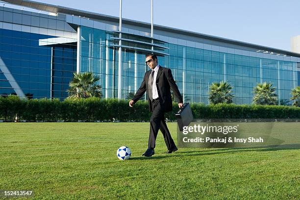 businessman playing with football - kicking bag stock pictures, royalty-free photos & images