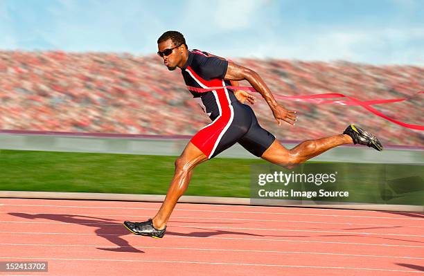 runner crossing the finish line - finish line ribbon stock pictures, royalty-free photos & images