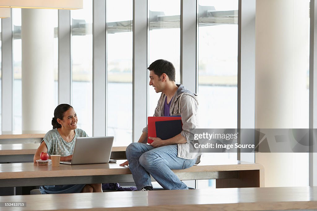 Mature students talking in classroom